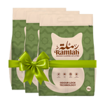 Two packages of Ramlah cat litter with a green bow on a white background