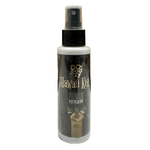 Bottle of Doggy's Hawaiian Kiss Premium Pet Perfume on a tiled floor with wooden panel background