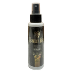 Bottle of Doggy's Hawaiian Kiss Premium Pet Perfume on a tiled floor with wooden panel background