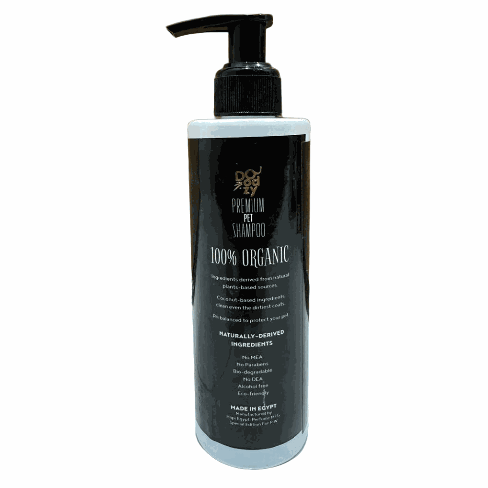 Black bottle of premium pet shampoo with pump on a wooden floor.
