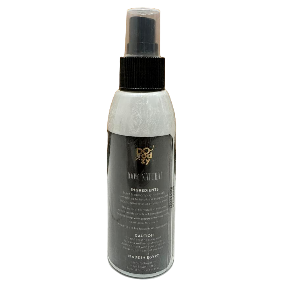 Spray bottle labeled 'Body Naturals' on a tiled floor with wooden wall background