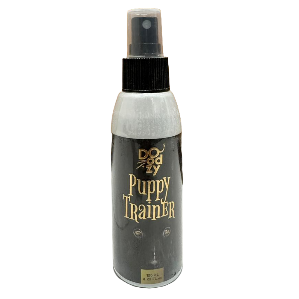 Bottle of Puppy Trainer spray on a tiled floor with wooden wall background
