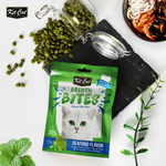 Kit Cat Breath Bites Seafood Flavor cat treat package with green herbs on a white background