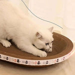White cat lying on a round brown cat scratcher with a patterned border.