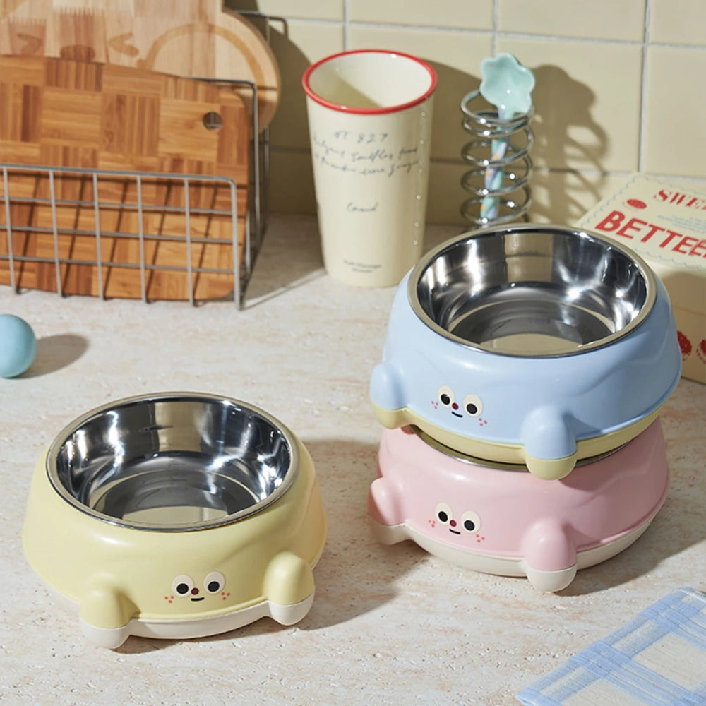 Two cute pet bowls in yellow and pink on a kitchen counter.