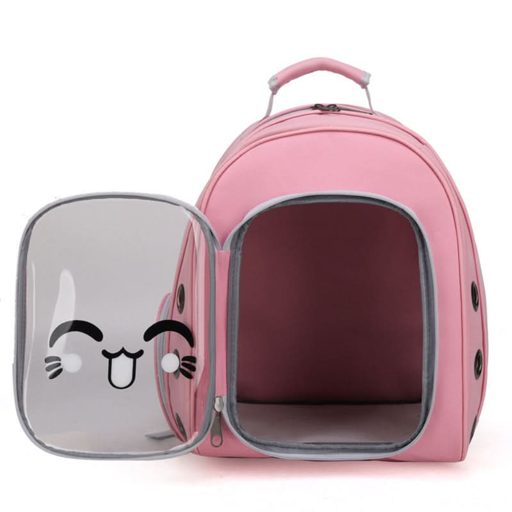 Pink pet carrier with transparent door featuring cartoon cat face on a white background