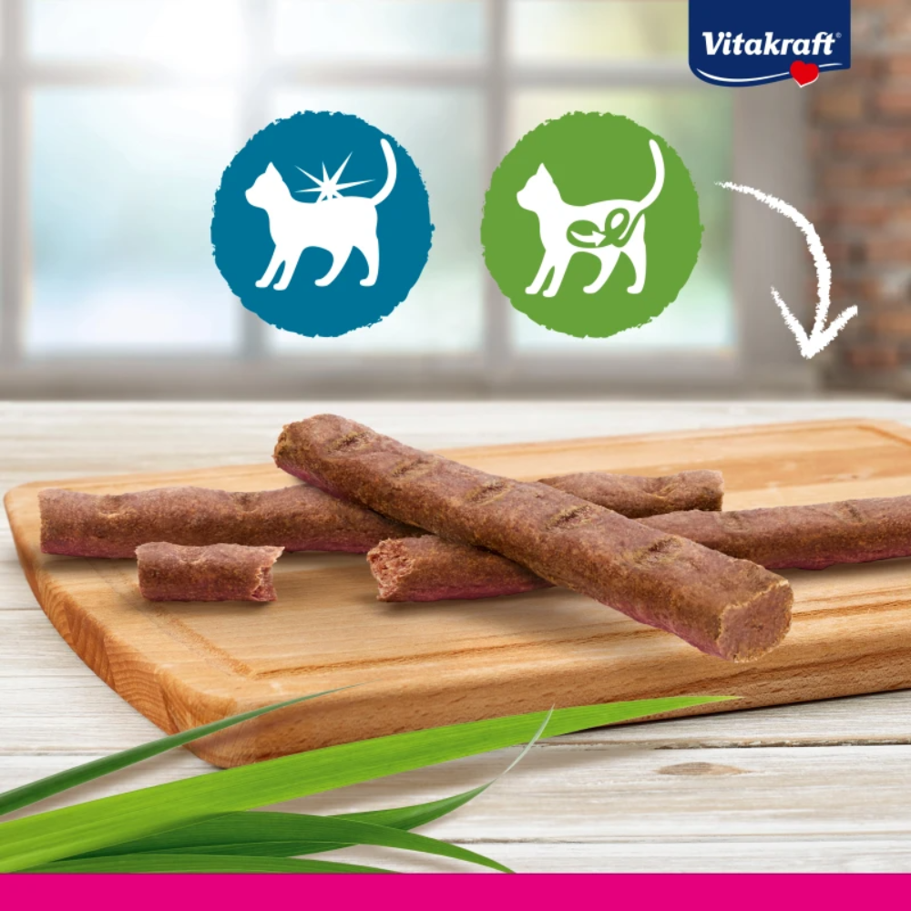 Dog treats on a wooden board with Vitakraft logo in the background