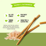Dog treat sticks with salmon and katsuobushi on a green background