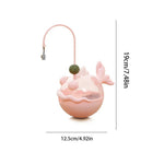 Pink whale-shaped product with measurements on a white background