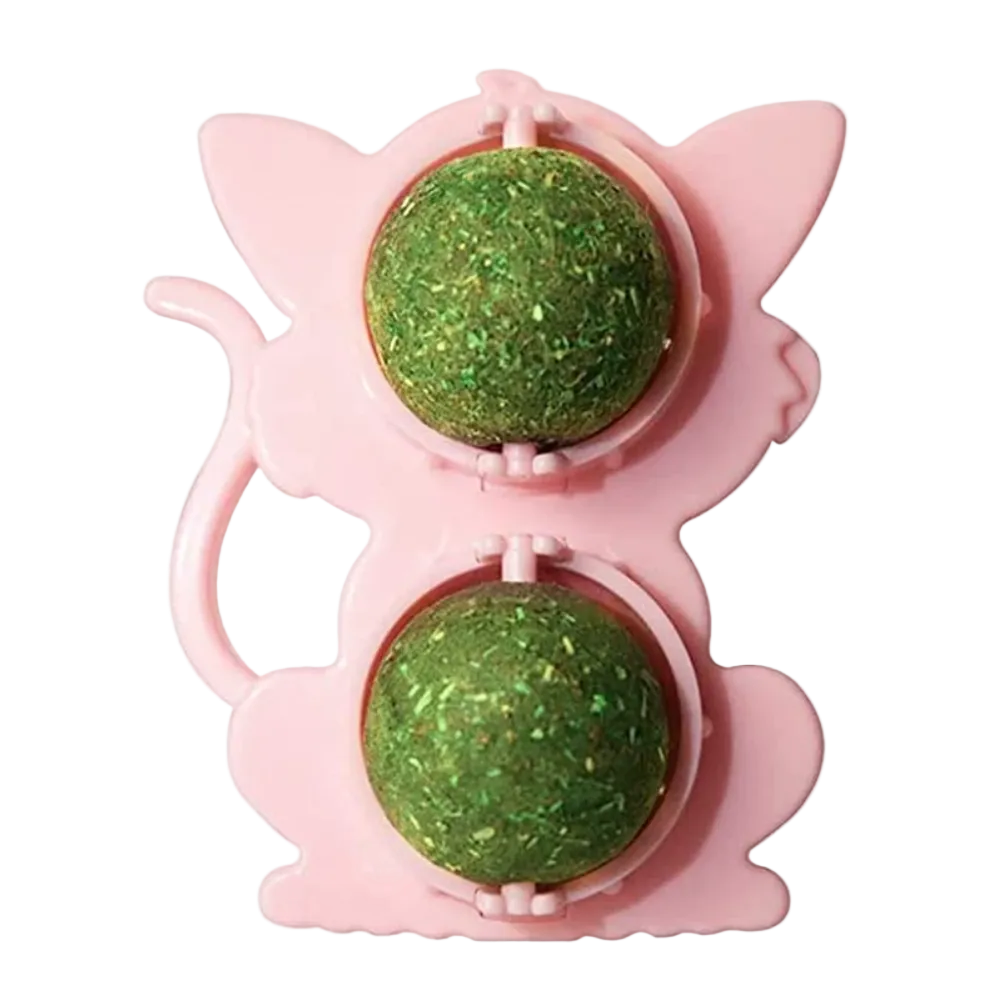 Pink cat-shaped toy with two green balls inside on a white background