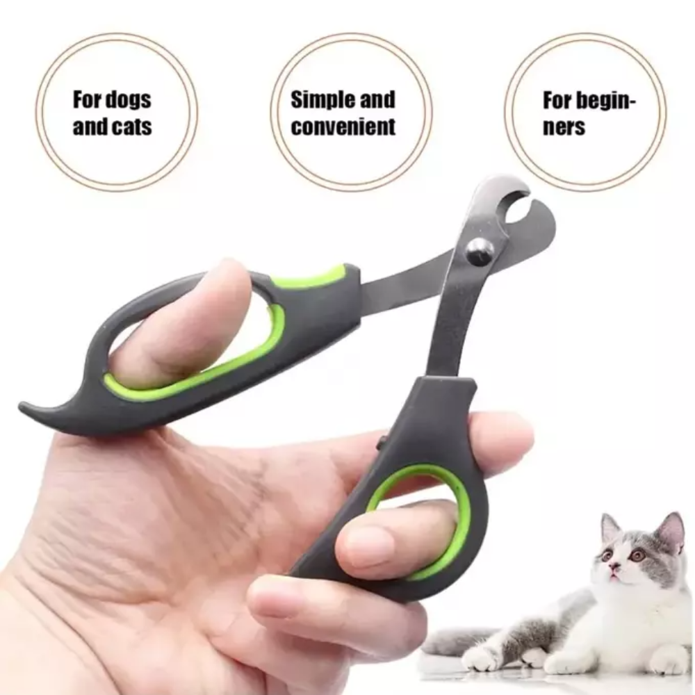 Pet nail clipper held by a hand with a cat in the background, labeled for dogs and cats, simple and convenient, and for beginners.