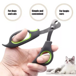 Pet nail clipper held by a hand with a cat in the background, labeled for dogs and cats, simple and convenient, and for beginners.