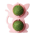 Pink cat-shaped toy with two green balls inside on a white background