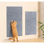 Cat interacting with two blue textured wall panels on a light-colored wall.