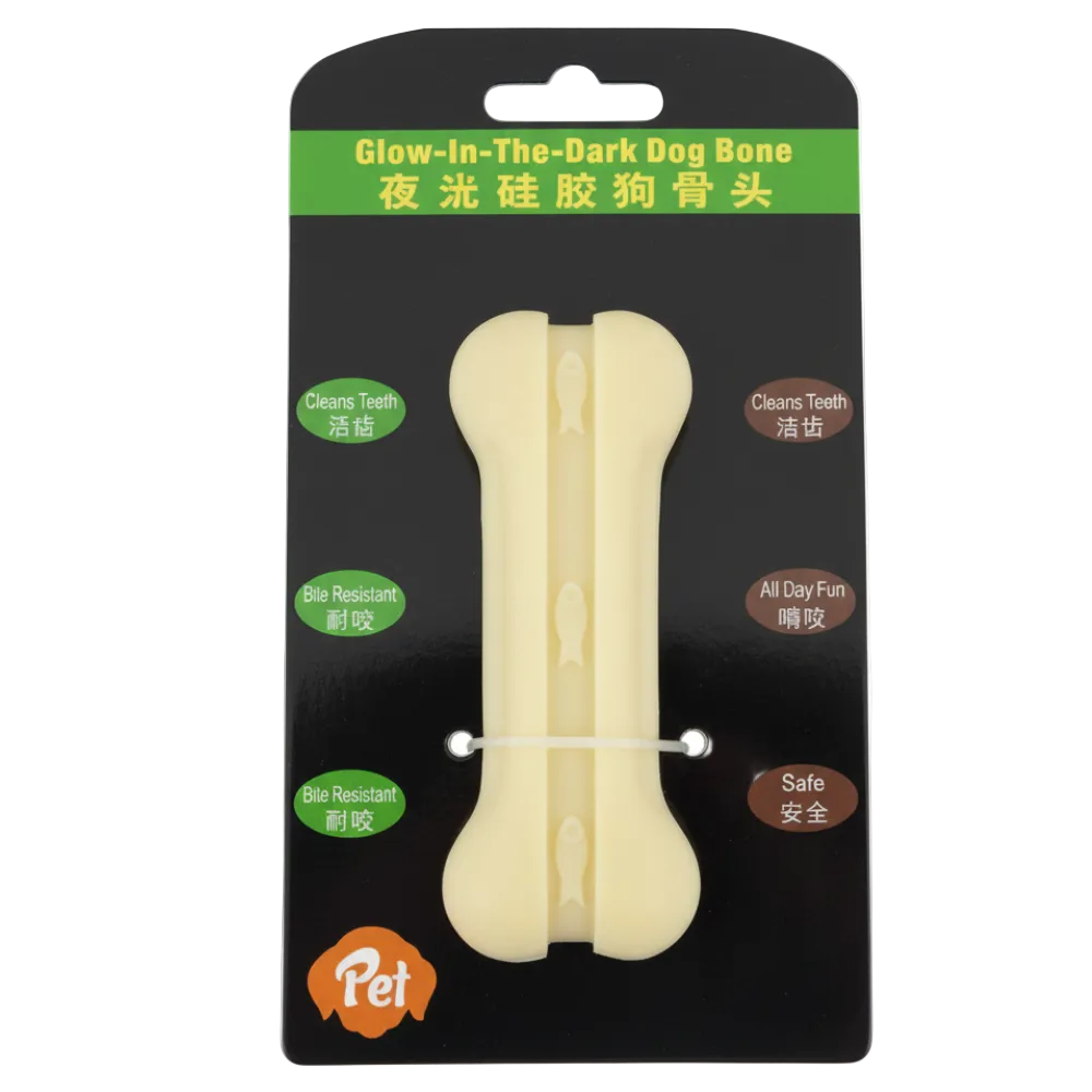 Glow-in-the-dark dog bone toy on black packaging with text and brand logo.