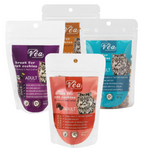 Four Véa cat food packages in different flavors on a white background
