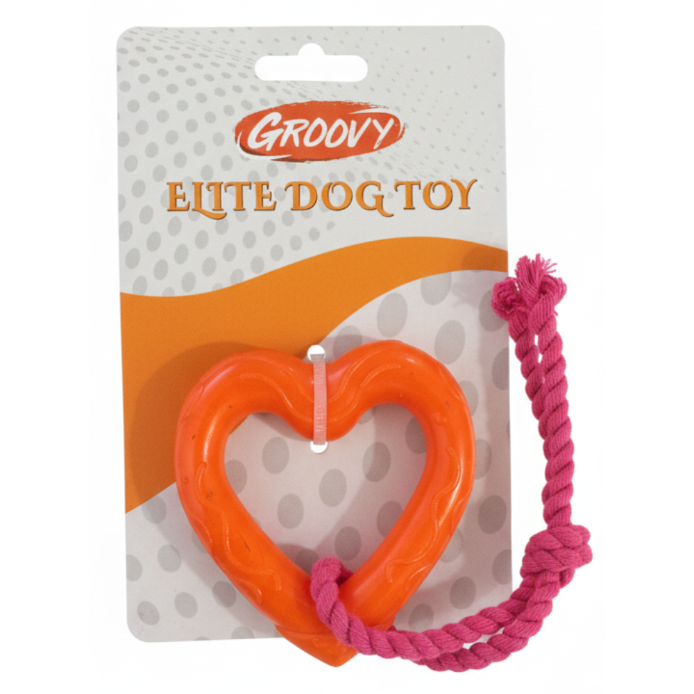 Orange heart-shaped dog toy with pink rope on a Groovy branded package.
