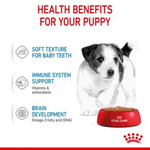 Advertisement for Royal Canin puppy food with a puppy and text about health benefits on a white background.