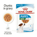 Royal Canin Puppy Mini wet dog food packaging with text and images of food and a puppy.