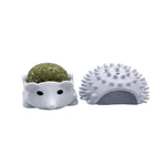 Hedgehog-shaped pet toy with a ball of kibble on a white background
