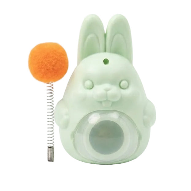 Green rabbit-shaped toy with an orange ball on a white background