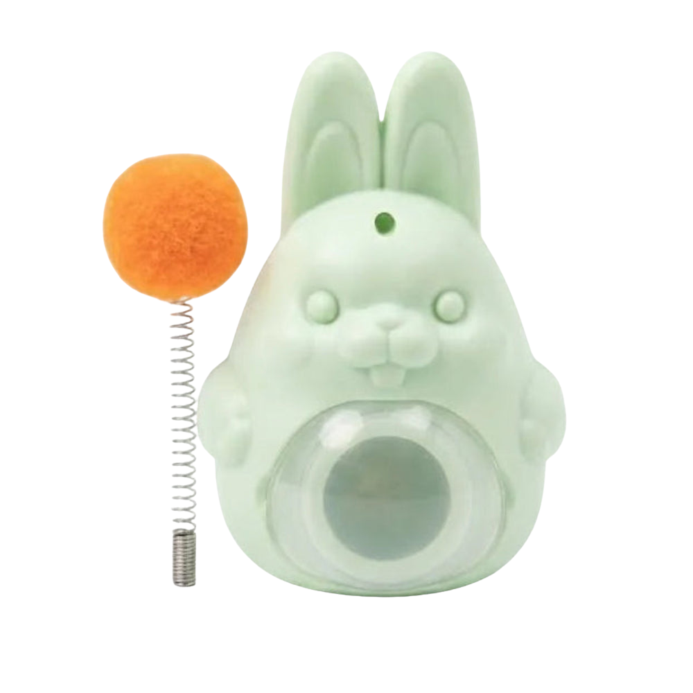 Green rabbit-shaped toy with an orange ball on a white background
