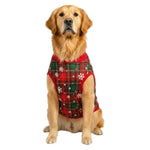 Dog wearing a red plaid sweater with white snowflake pattern on a white background