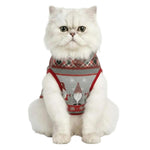 Cat wearing a festive sweater with a reindeer design on a white background