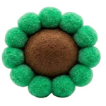 Green felt ball flower with a brown center on a white background