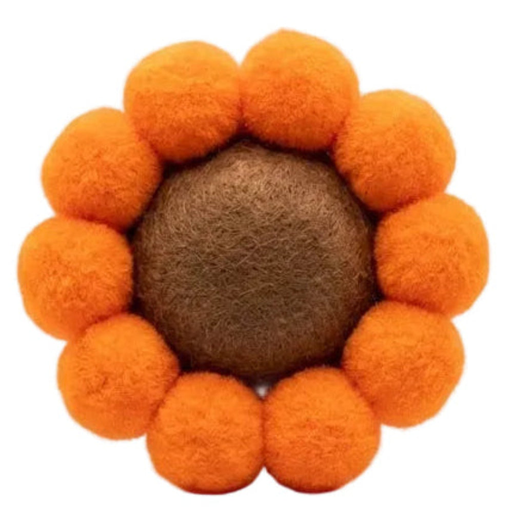 Sunflower-shaped toy with orange petals and a brown center on a white background