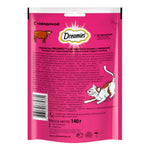 Dreamies cat food packaging with text and images of a cat and cow on a pink background