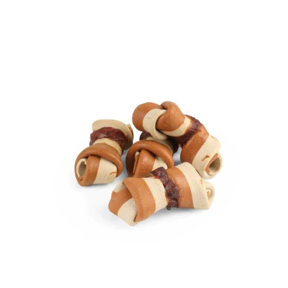 Wooden dog chew toys with natural materials on a white background