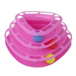 Pink plastic toy with colorful balls on a white background
