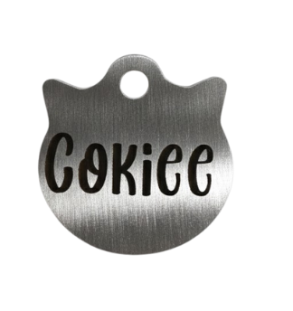 Metallic pet tag with 'Cokie' engraved on a white background