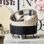 Decorative metal bowl with black base on a magazine with 'London' text