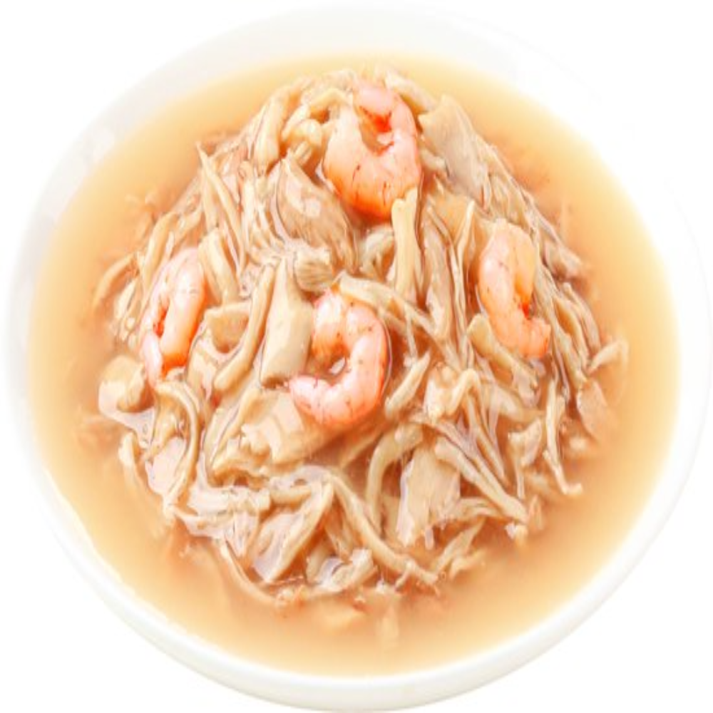 Noodle dish with shrimp in a light broth on a white plate