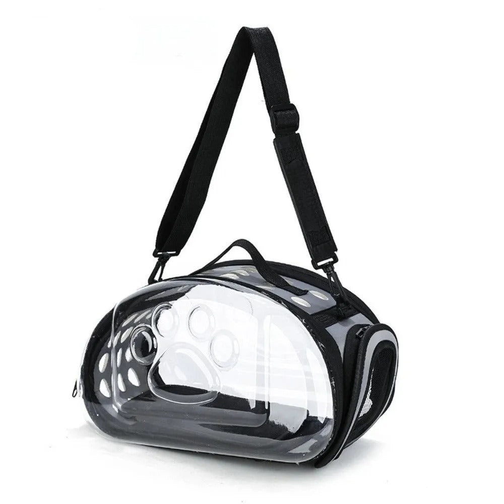 Clear pet carrier with black straps on a white background