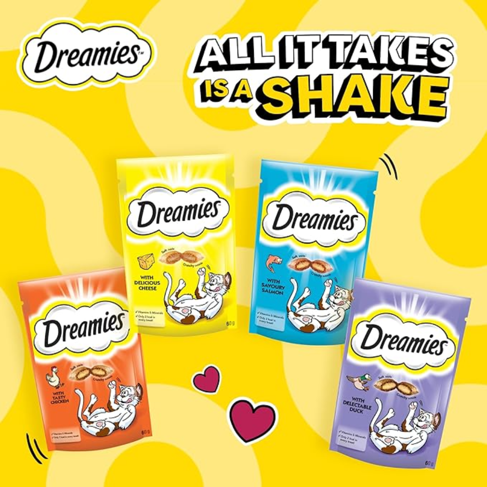 Four Dreamies cat treat packages on a yellow background with text 'All It Takes Is A Shake'.
