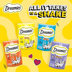 Four Dreamies cat treat packages on a yellow background with text 'All It Takes Is A Shake'.