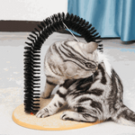 Cat using a self-grooming brush on a light-colored surface with a blue curtain in the background.