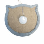 Cat-shaped scratching pad with a white pom-pom on a beige background