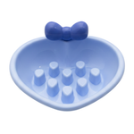 Blue silicone dish with a bow on a white background