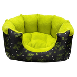 Pet bed with green interior and black exterior with white patterns on a white background