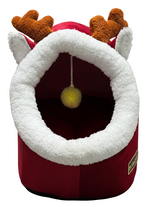 Red pet bed with white fur trim and brown antlers on a white background