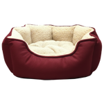 Red pet bed with beige interior on a light gray background