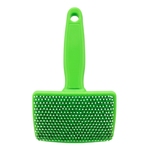 Green pet grooming brush with a white background