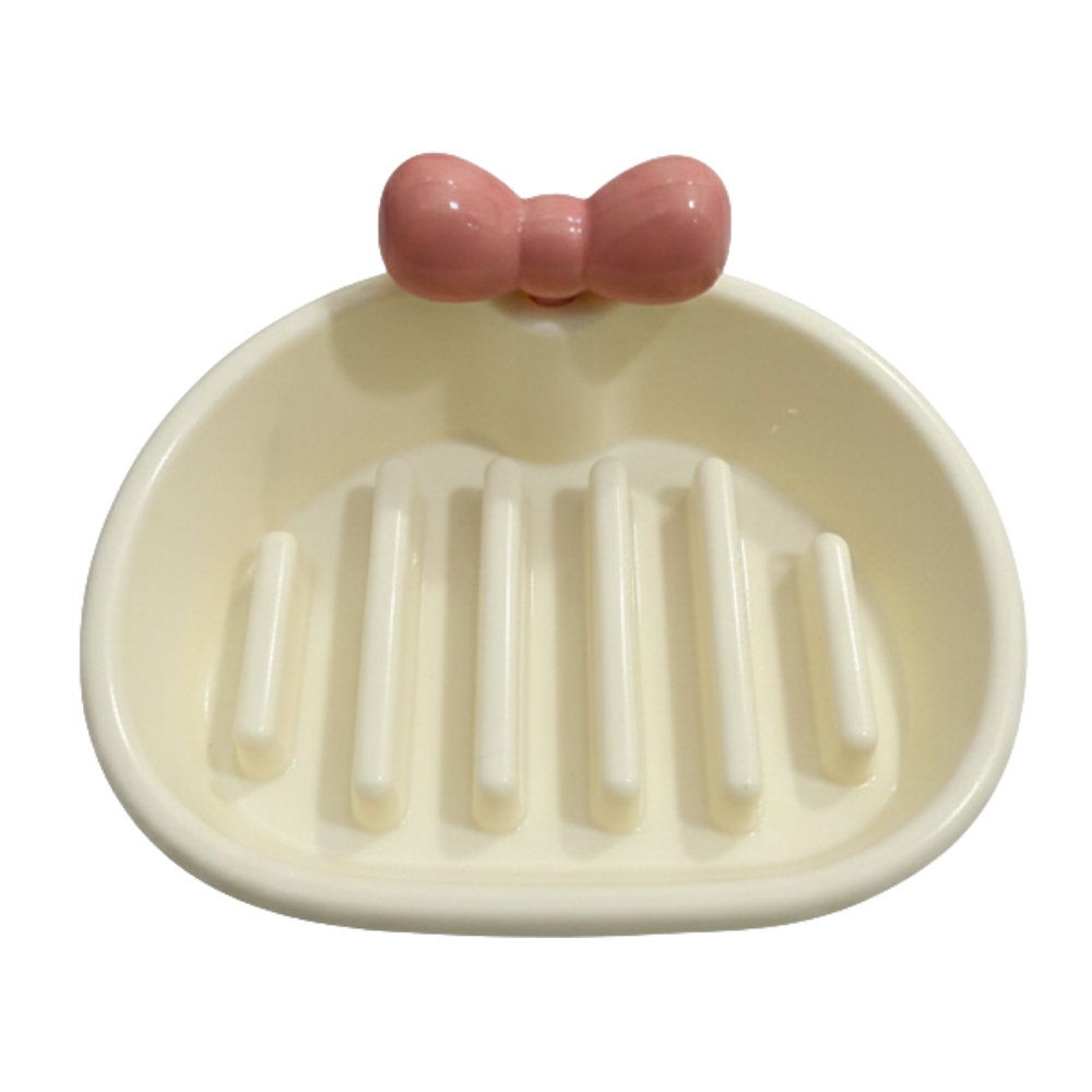 Ceramic soap dish with a pink bow on a white background