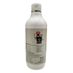 White bottle with a label featuring a cartoon character on a wooden surface.