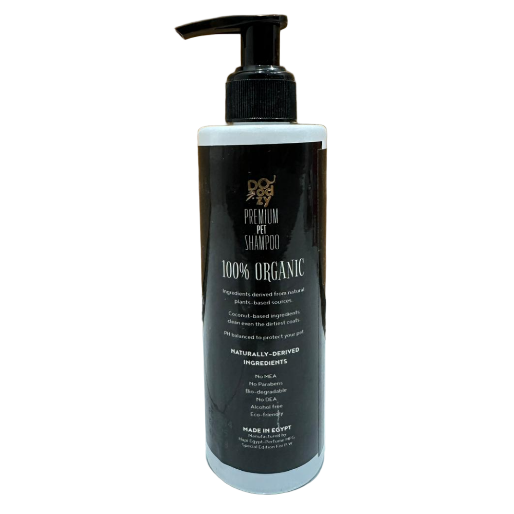 Black bottle of premium pet shampoo with pump on a wooden floor.