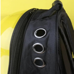 Black bag with circular breathing holes on a yellow background